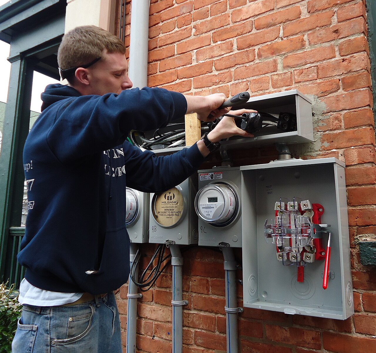 Electrician working on outdoor meters and panels