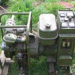 Portable engine-generator set up outdoors on grass
