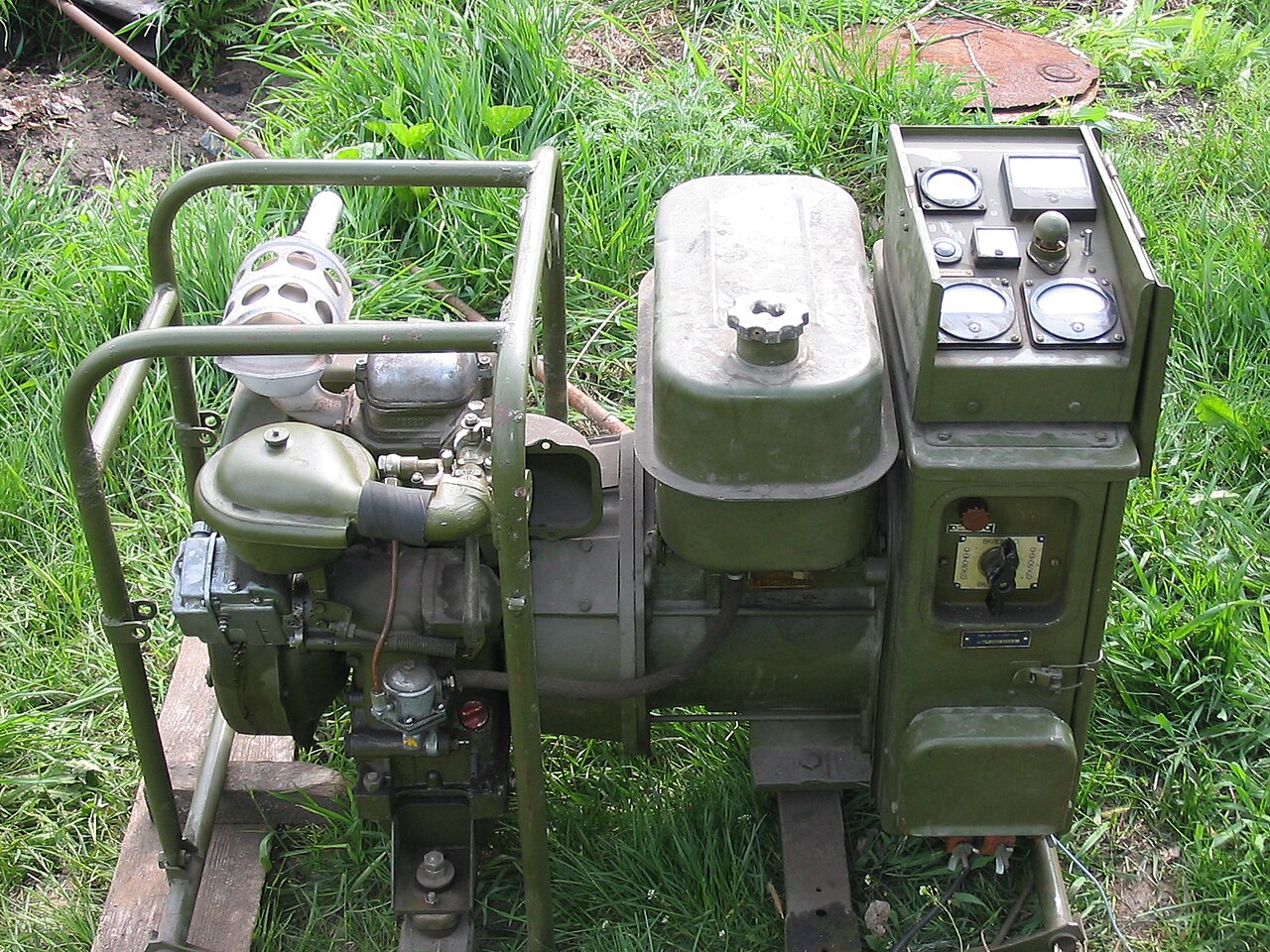 Portable engine-generator set up outdoors on grass