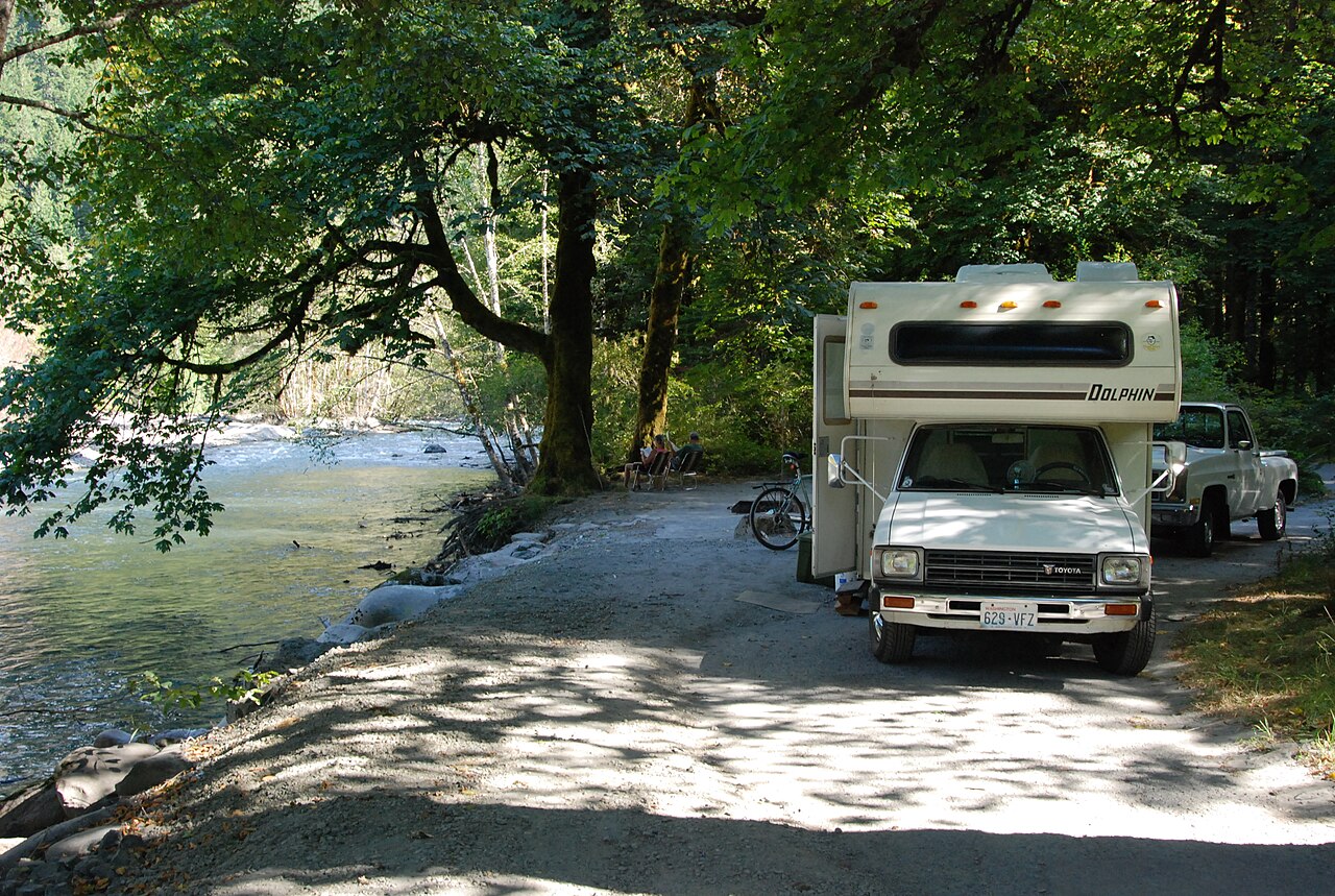 Motorhomes parked at a riverside campground
